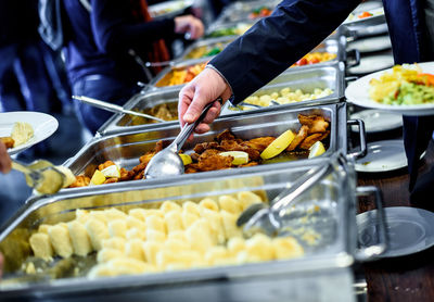 Cropped image of hand taking food