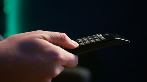 Cropped hand using calculator