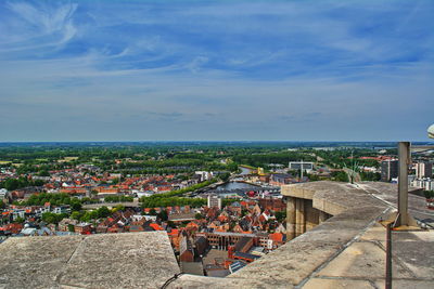 High angle view of townscape by sea against sky