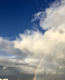 Low angle view of rainbow in sky