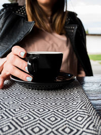 Midsection of woman using mobile phone