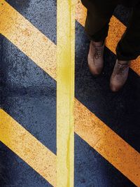 Low section of woman standing on tiled floor