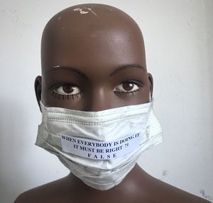 Close-up of mannequin with mask and quotes