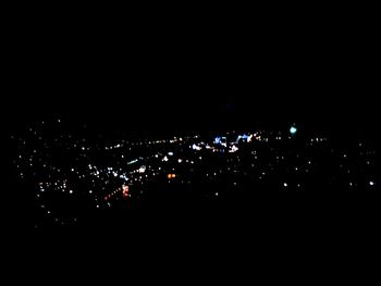 Silhouette crowd at music concert against sky at night