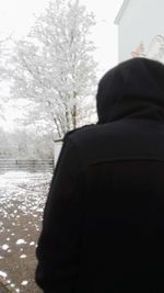 Rear view of man standing in snow