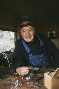Portrait of smiling male mechanic at workshop