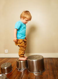 Portrait of boy standing against wall