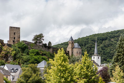 Panoramic view of castle and trees against sky