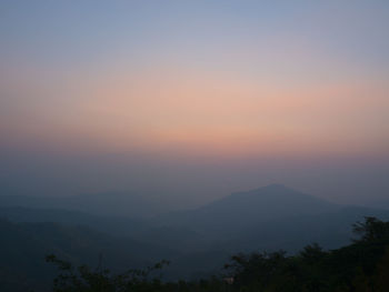 Scenic view of silhouette mountains against sky at sunset