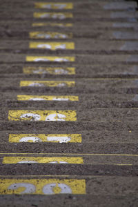 High angle view of yellow arrow symbol on road