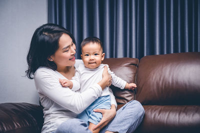 Mother and daughter sitting on floor