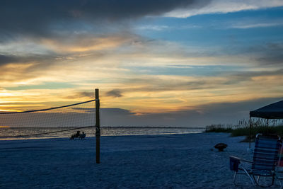 Scenic view of beach against sky during sunset