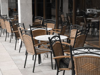 Empty chairs and tables at outdoor cafe