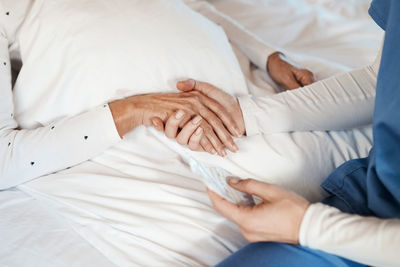 Midsection of doctor examining patient in hospital