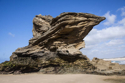 Low angle view of rock formations against sky