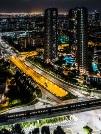 High angle view of illuminated buildings in city at night