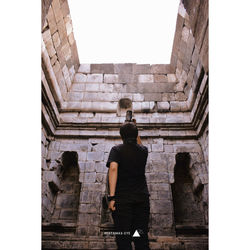 Rear view of man standing outside building