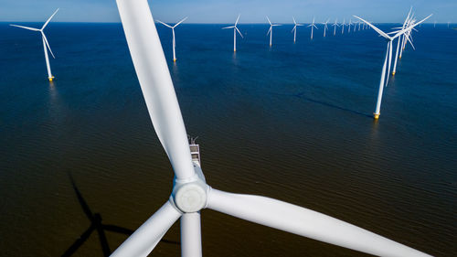 Low angle view of windmill against sky