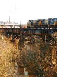 Train on railroad track against clear sky