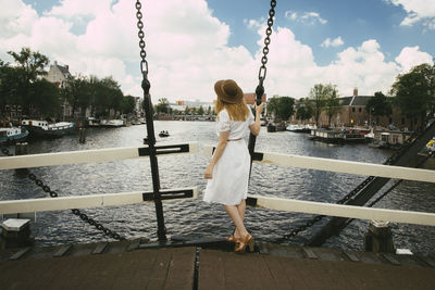 Woman on bridge overlooking city