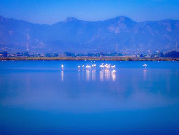 Scenic view of lake with mountain range in background