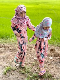 Two children playing at paddy field