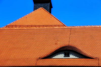 High section of roof against clear blue sky
