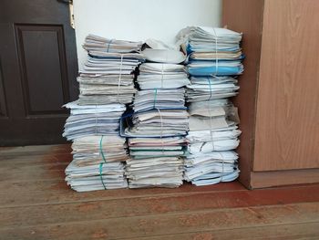Close-up of stack on table against wall