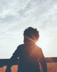 Rear view of silhouette man standing against sky during sunset