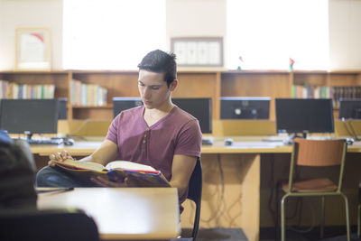 Young man sitting on table