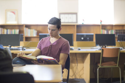 High school student reading a book