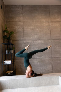 Side view of woman exercising on floor