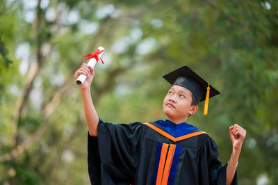 Portrait of smiling young man holding umbrella