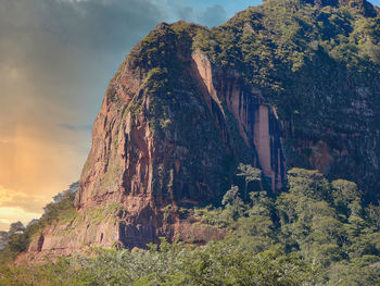 View of rock formation on mountain against sky