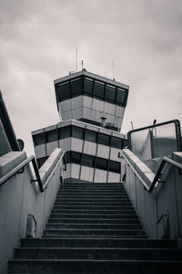 Low angle view of steps leading towards building against sky