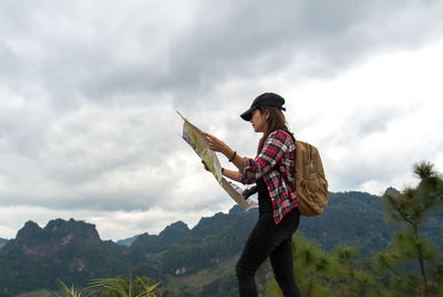 Full length of man standing on mountain against sky