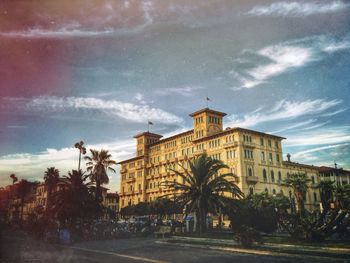 Buildings against cloudy sky