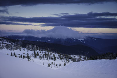 Scenic view of mountains against sky during winter