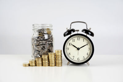 Close-up of coins on table against white background