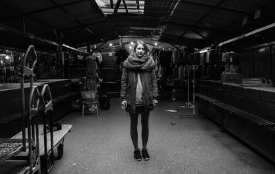 Full length of woman standing on illuminated railroad station