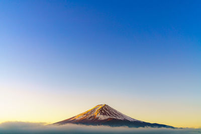 Scenic view of snowcapped mountain against clear blue sky