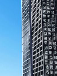 Low angle view of modern building against clear blue sky