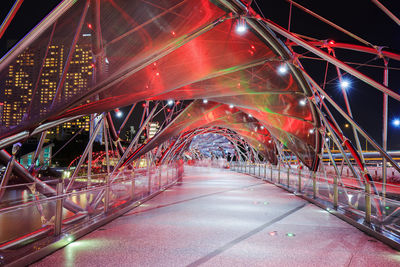 Illuminated bridge in city at night