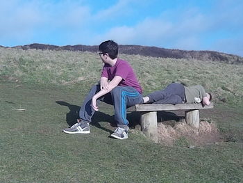 Woman sitting on grassy landscape