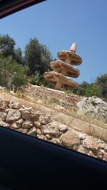 Built structure by trees against clear blue sky