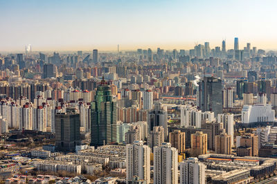 Aerial view of modern buildings in city against sky