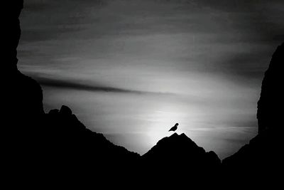 Low angle view of silhouette mountain against sky at sunset