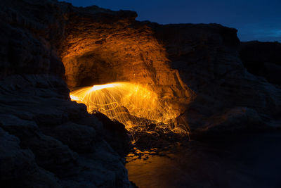 Illuminated wire wool at rock formation