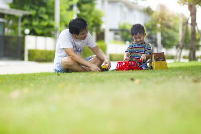 Rear view of boys playing on grass