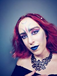 Portrait of beautiful woman against gray background